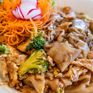 Pad See Ew served with 1 Crispy Veg Roll